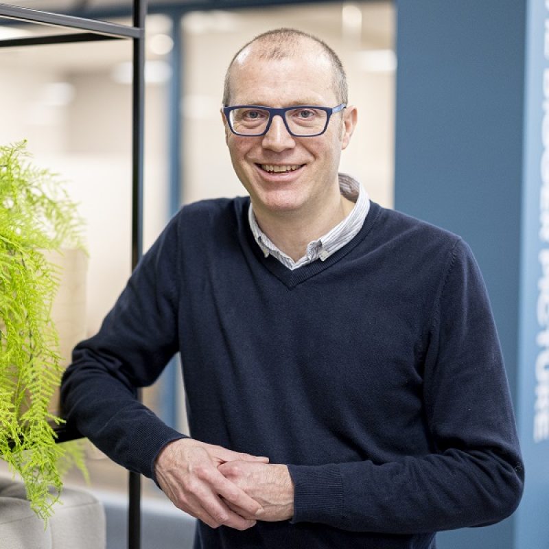 man leaning on side while smiling